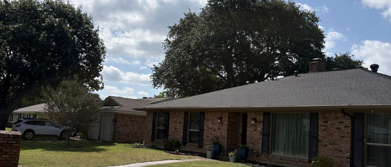 Wide view of a thick, healthy lawn and clean edges at a brick North Texas home